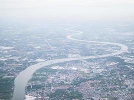 Soft focused of aerial view of Bangkok city and Chao Phraya river with morning fog overlay, capital of Thailand photo