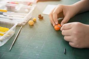 Boy is playing polymer clay photo