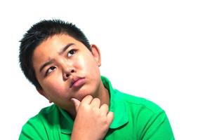 Asian 13 years old boy making thinking expression isolated over white  background photo