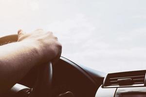 Man driving car using one hand photo