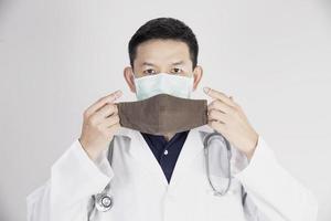 Asian doctor is wearing double layer masks for protecting Covid-19 virus - medical people working concept photo