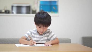 Boy drawing at home video