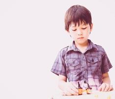 Vintage style of Asian lovely boy is playing Halloween clay happily photo