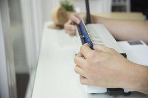 Man making report using comb binding machine - people working with stationary tools concept photo