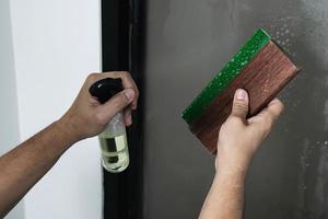 People installing sticker film to mirror window house interior decoration photo