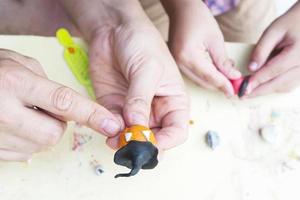 Father is playing Halloween clay with his son over white background photo