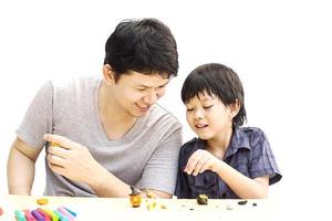 Father is playing Halloween clay with his son over white background photo