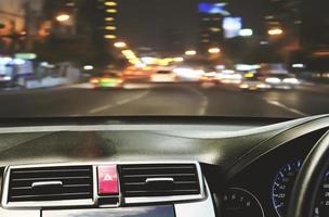 Front view of car looking out from inside with twilight road background photo