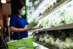 Woman shopping fresh fruit during COVID-19 spreading in Thailand local fresh market photo