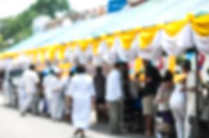 Blurred picture of people participate event at temple in Chiang Mai, Thailand photo