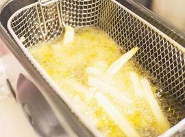 French fries in hot oil pan photo