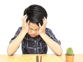 Angry boy is shouting while doing his assignment photo