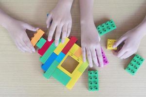 Kids playing pieces plastic creative construction blocks photo