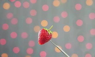 Fresh Strawberries over colorful light bokeh background photo