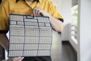 Air conditioner maintenance man showing dirty screen preparing to clean during hot season in Thailand photo