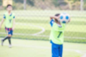 Blurred photo of children are practicing soccer in football field