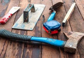 Construction hand tools over wooden floor photo