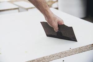 Man preparing electric router laminate trimmer machine tool - carpenter workshop concept photo