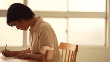 Woman writing a letter video