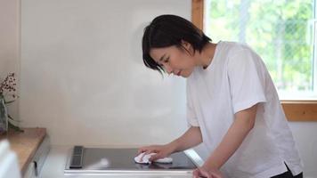 Woman wiping the cooking heater video