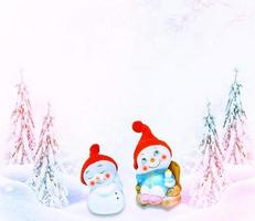 Happy snowman on a winter landscape background. photo