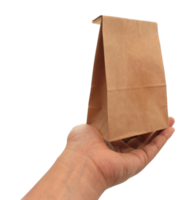 hand holding a brown paper bag on transparent background png file