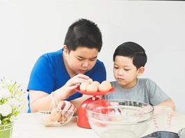 Asian boys are making cake photo