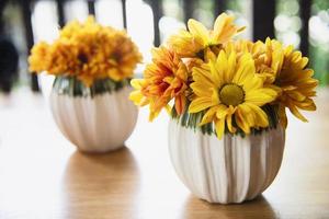 Fresh colorful small sun flower in ceramic pot - yellow flower decoration for background use photo