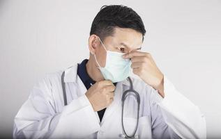 Asian doctor is wearing double layer masks for protecting Covid-19 virus - medical people working concept photo