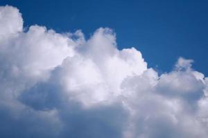 Blurred background. Blue sky and white fluffy clouds. photo