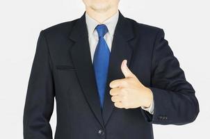 Businessman is doing thumps up sign over white background. Photo is focused at hand. Photo includes clipping path.