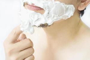 Man is smearing foam to his face prepare for shaving photo