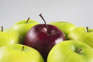 Fresh colorful apple over gray background - clean fresh fruit background concept photo