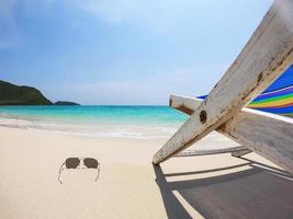 Relax beach chair with fresh coconut on clean sand beach with blue sea and clear sky - sea nature background relax concept photo