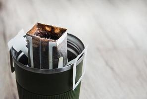 goteo de café en una taza de café caliente de acero con espacio para copiar, concepto de cafetera caliente instantánea
