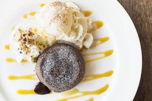 Chocolate lava cake in white plate on old wooden table photo