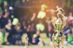 Sport trophy over blur crowded people in school sport day festival photo