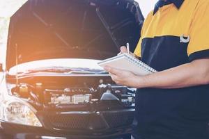 Mechanic man repairing car photo