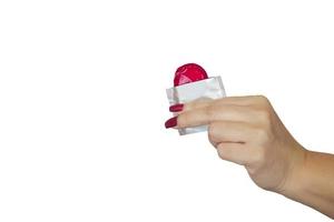 Lady's hand showing red condom photo