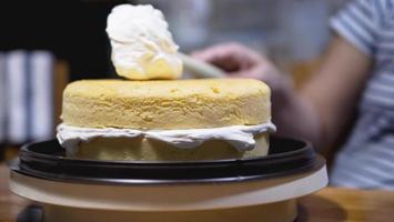 Lady making cream cake - people with homemade bakery concept photo