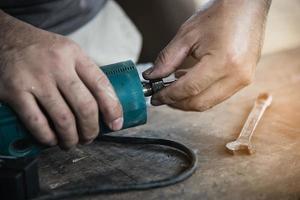 Man preparing electric router laminate trimmer machine tool - carpenter workshop concept photo