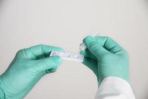 Doctor showing rapid antigen test Covid -19 self repid test set photo