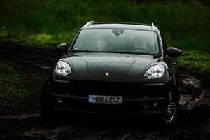 CHISINAU, MOLDOVA - JUNE 17, 2021, Porsche Macan S in off-road racing full of mood on bad road in Moldova. Editorial photo. photo