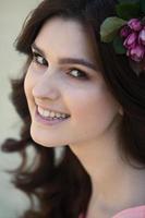 beautiful white european girl with clean skin in the park with flowering trees photo