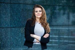 Confident business expert. Happy successful professional posing near office building. European girl. Russian business lady. Female business leader concept. Portrait Of Successful Business Woman photo