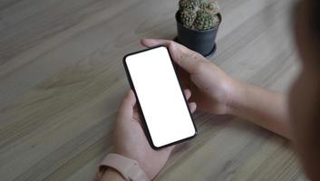 cell phone blank white screen mockup.woman hand holding texting using mobile on desk at office.background empty space for advertise.work people contact marketing business,technology photo