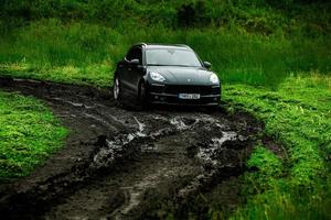 CHISINAU, MOLDOVA - JUNE 17, 2021, Porsche Macan S in off-road racing full of mood on bad road in Moldova. Editorial photo. photo