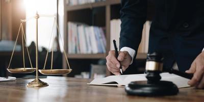 justice and law concept.Male judge in a courtroom on wooden table and Counselor or Male lawyer working in office. Legal law, advice and justice concept. photo