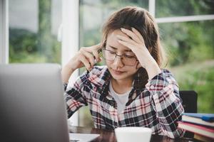 Tired businesswoman working on a computer photo