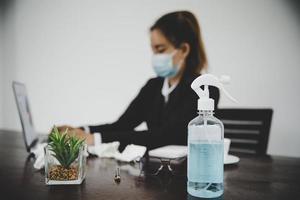 Sick young asian business woman wearing protective face mask photo